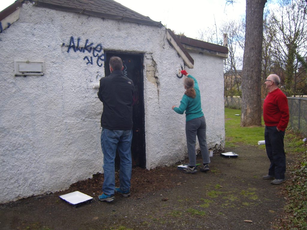 FoRP members painting over graffiti on pavilion